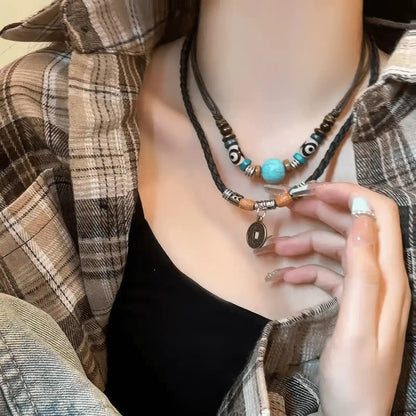 New Chinese ethnic style braided pendant necklaces worn, complementing a plaid shirt and black top, highlighting layered look