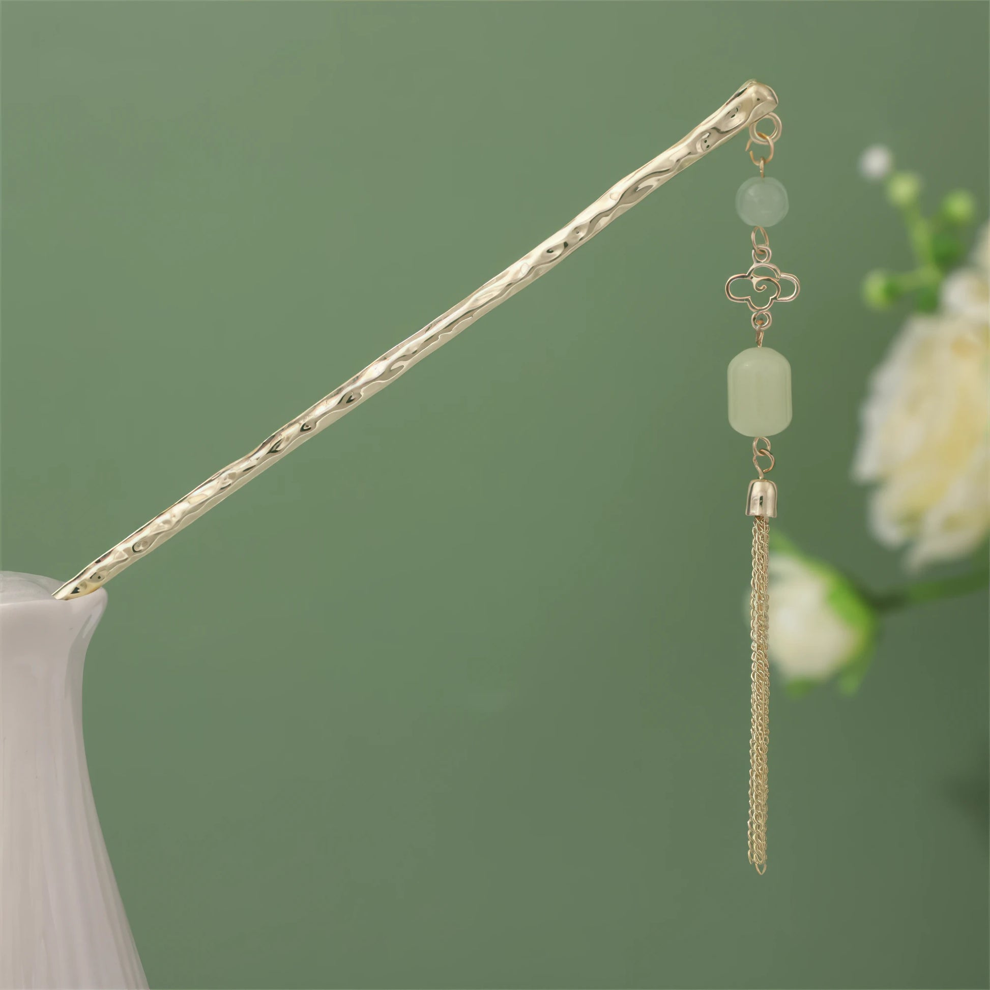 Nianchunxian hairpin with green jade and gold tassel, gold rod in white vase on green background
