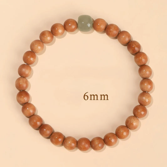 Single - circle old peach wood bracelet, 6mm beads, with green jade - like accent bead