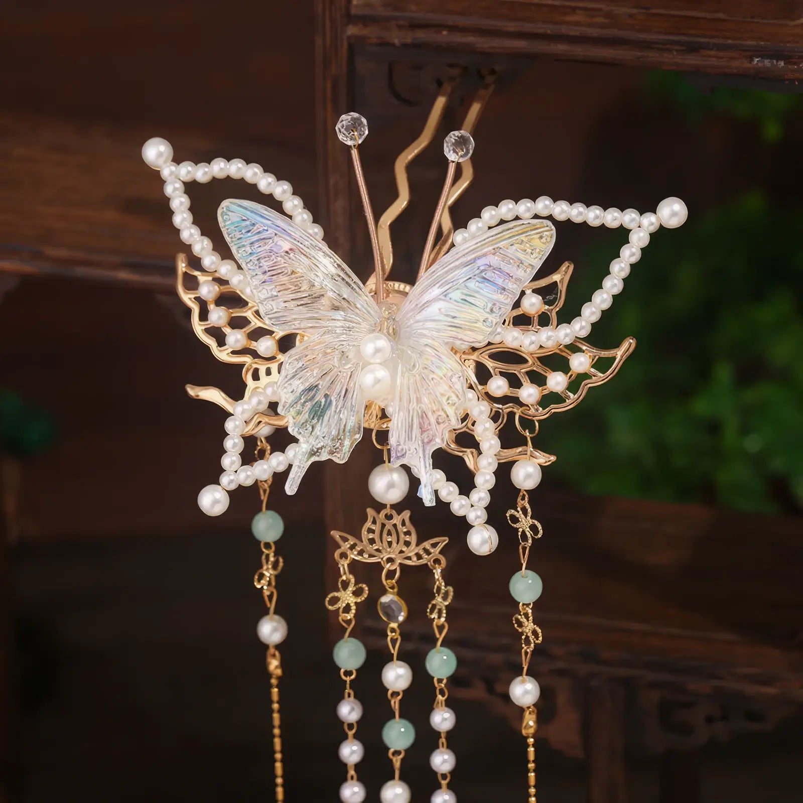 A third pearl - adorned butterfly tassel hairpin with a number 3 in the bottom - right corner on a simple Chinese - style furniture background