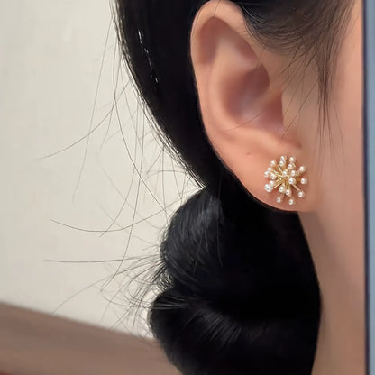 Pearl popcorn earrings worn on ear, showcasing delicate design
