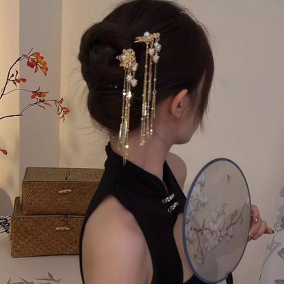Pearl tassel hairpin worn in half-up hairstyle, side profile view