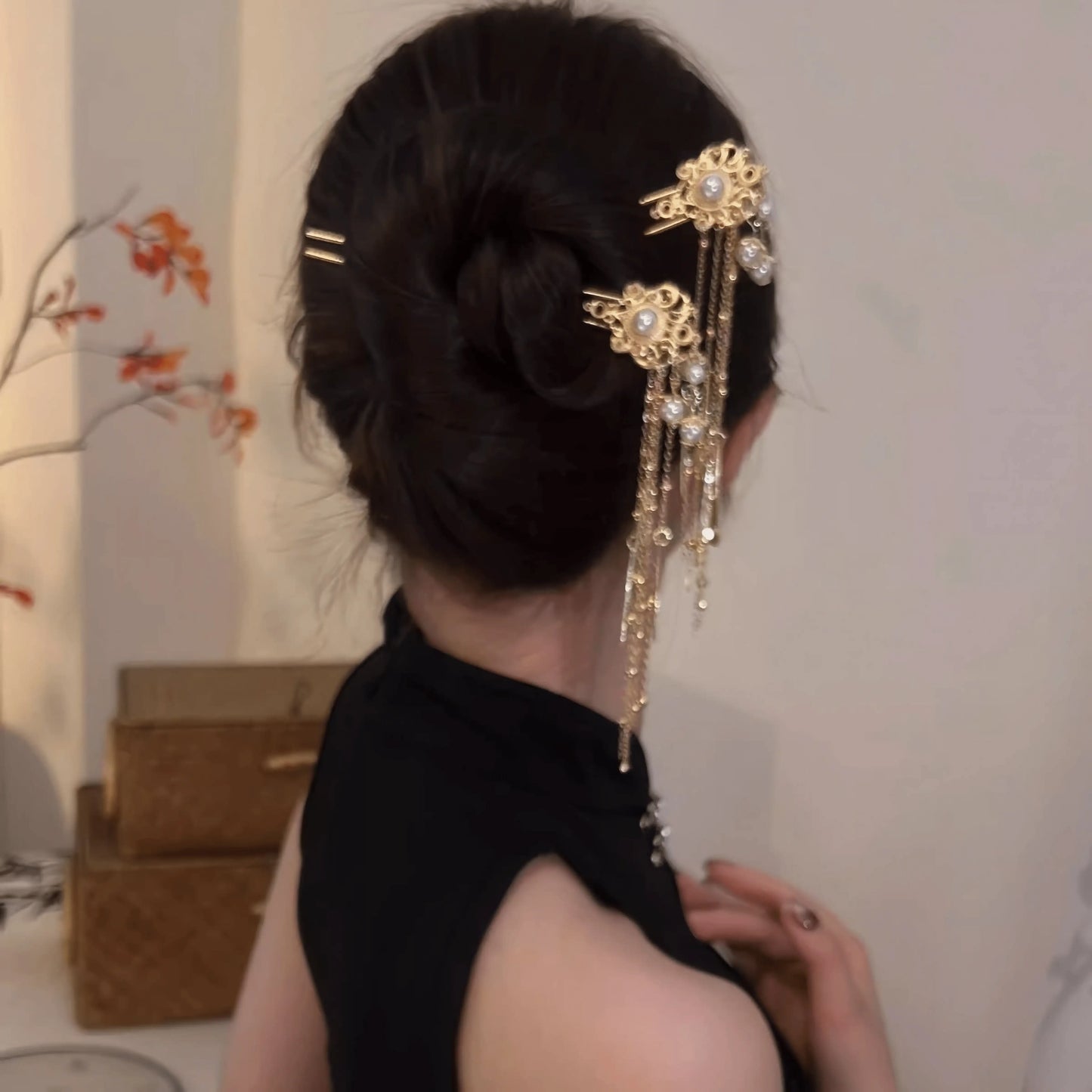 Pearl tassel hairpin worn in updo, side view with swinging tassels