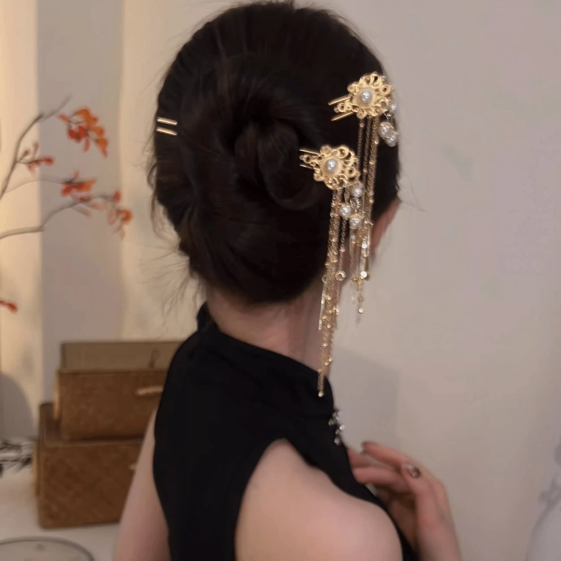 Pearl tassel hairpin worn in updo, side view with swinging tassels