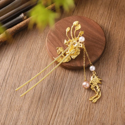 An angled view of the phoenix travel hairpin, on a bamboo background