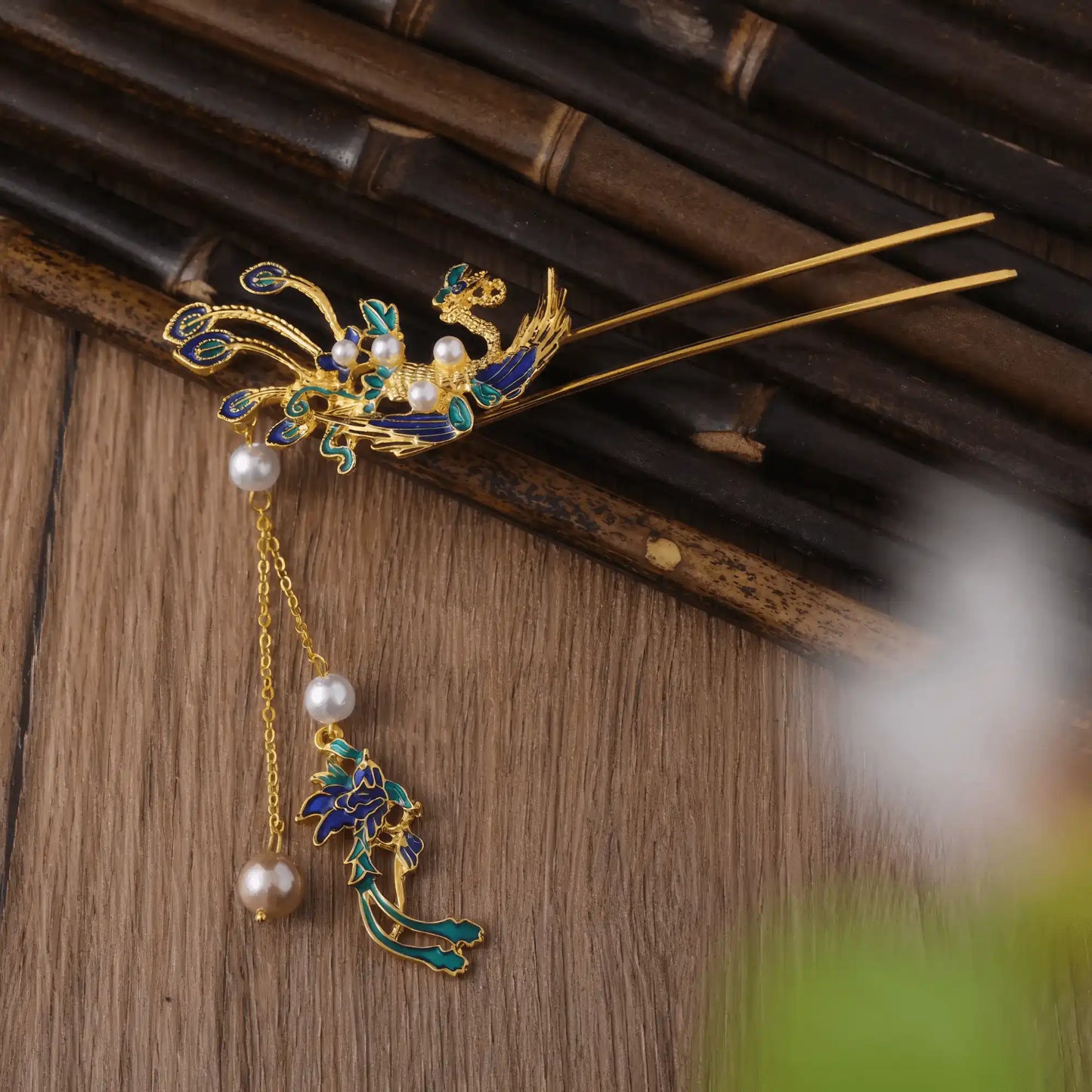 Close - up of the tassels at the bottom of the phoenix travel hairpin, on a simple white background
