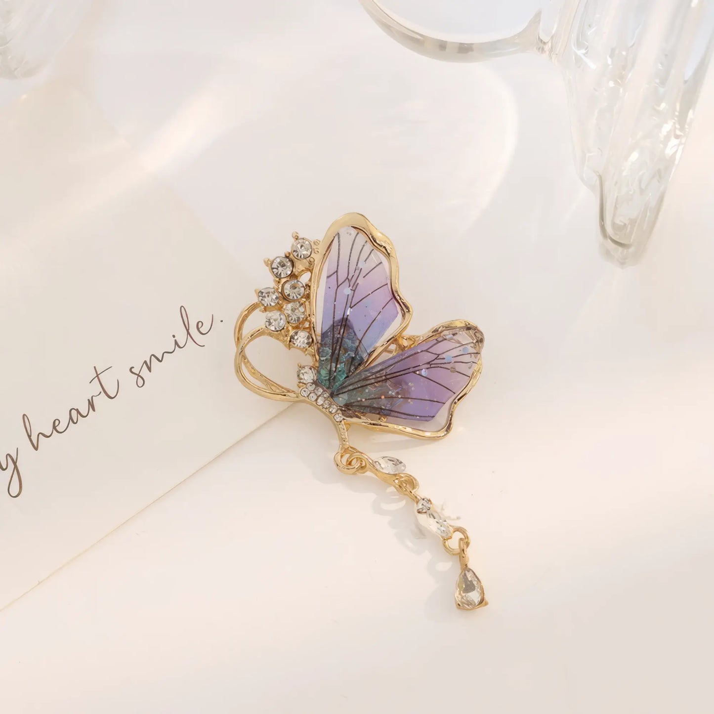 Purple butterfly brooch with rhinestone accents, elegant design
