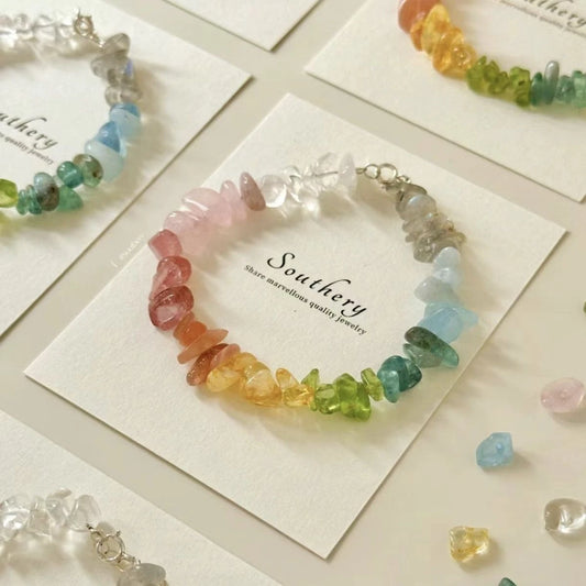 Rainbow chip stone bracelets placed on “Southery” cards with scattered stones