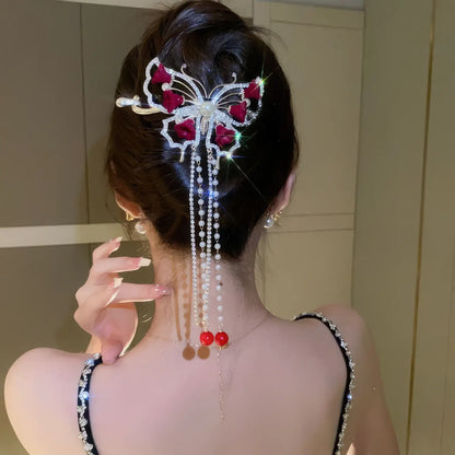 Red flower butterfly hair clip worn in updo hairstyle (back view)
