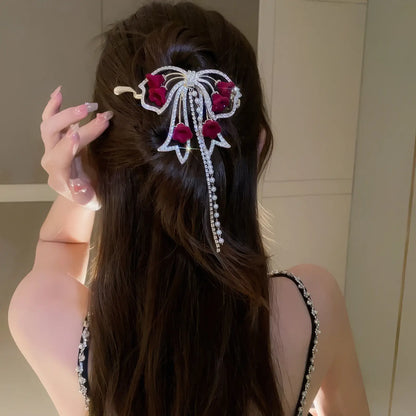 Red flower butterfly hair clip worn in half - up hairstyle (side view)