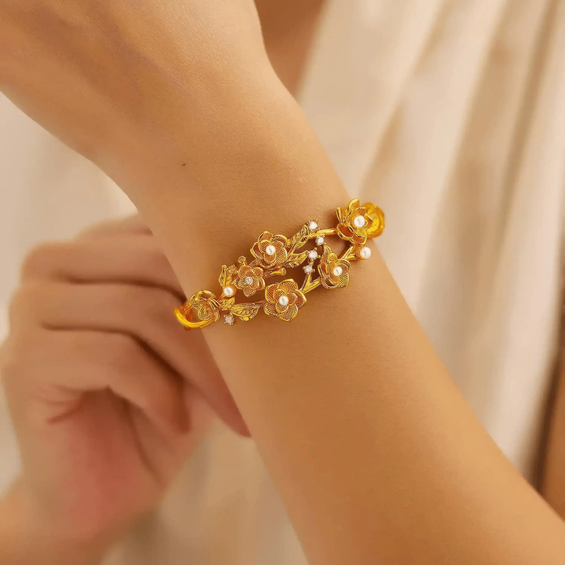 Gold rose pearl bracelet worn on wrist, highlighting delicate craftsmanship