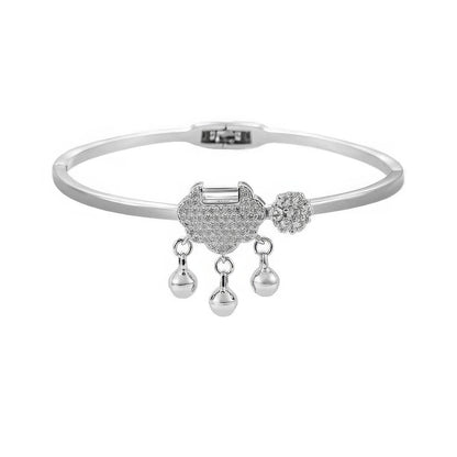 Silver safety lock bracelet, isolated on white background, highlighting delicate pattern