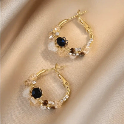 Sea blue champagne wreath earrings displayed on fabric, emphasizing design