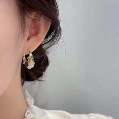 Sea blue champagne wreath earring worn on ear, emphasizing elegance
