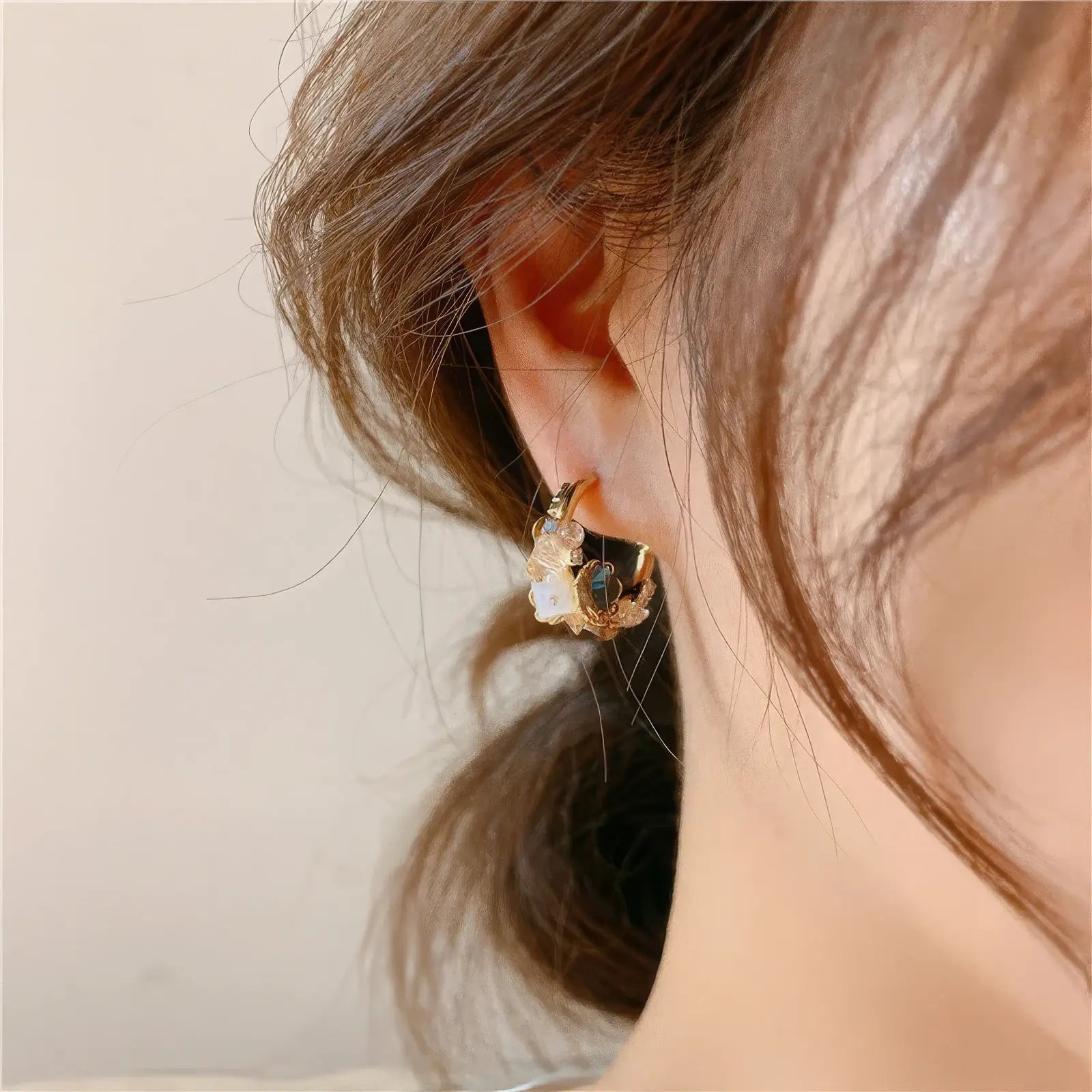 Sea blue champagne wreath earring worn on ear, highlighting style