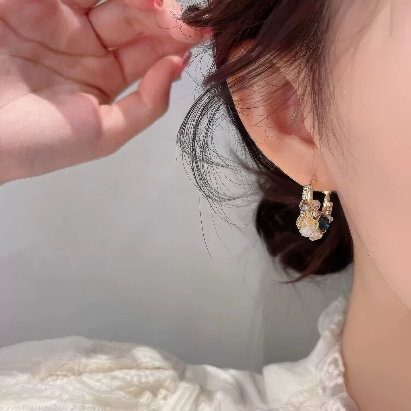 Sea blue champagne wreath earring worn on ear, showcasing craftsmanship