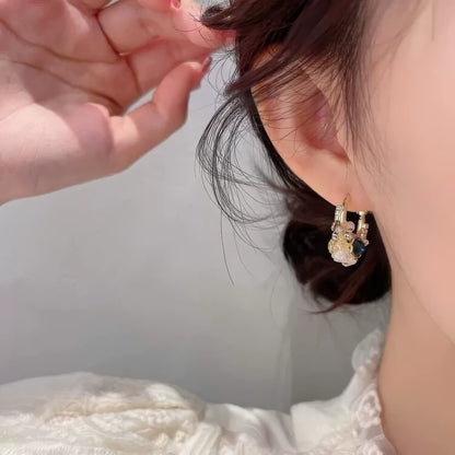 Sea blue champagne wreath earring worn on ear, showcasing craftsmanship