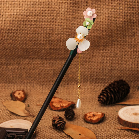 Shantaohong hairpin 4 with black rod, orange flower and orange bead tassel, linen background with pinecone and wood chips
