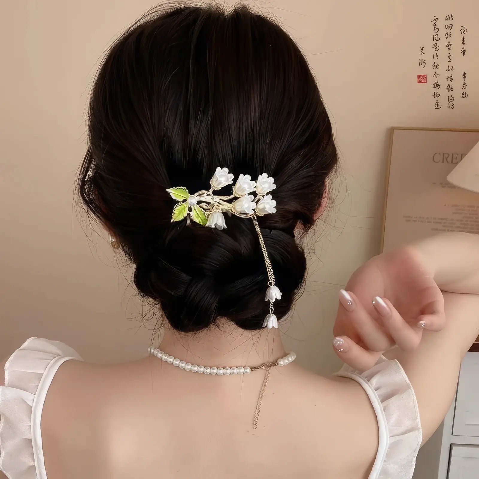 Tassel buya four - teeth comb with flower design worn in an updo hairstyle