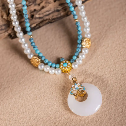 Turquoise peace buckle necklace with pearls, displayed on wooden board, close - up view
