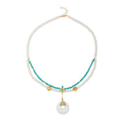 Turquoise peace buckle necklace with pearls, isolated on white background
