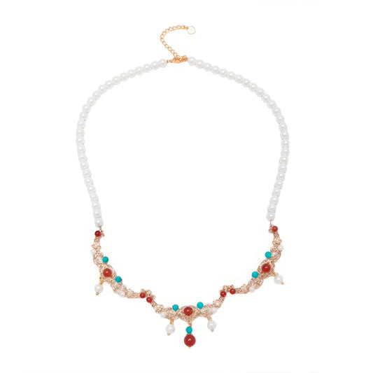 Turquoise and shell pearl necklace isolated on white background