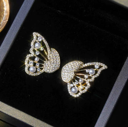 Gold two - way wear butterfly diamond earrings, placed in black box