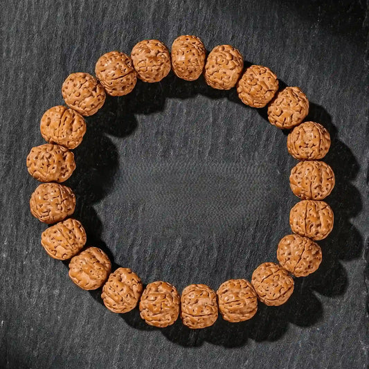 Single - strand plain vajra bodhi bracelet, isolated on dark background

