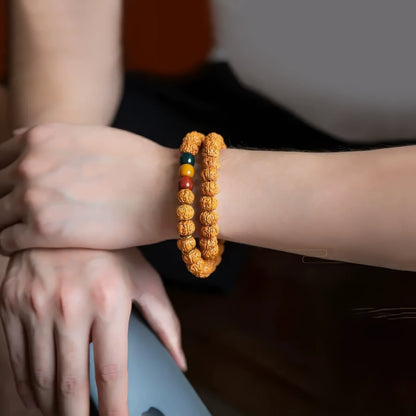 Vajra bodhi bracelet worn on wrist, light - colored clothing in background