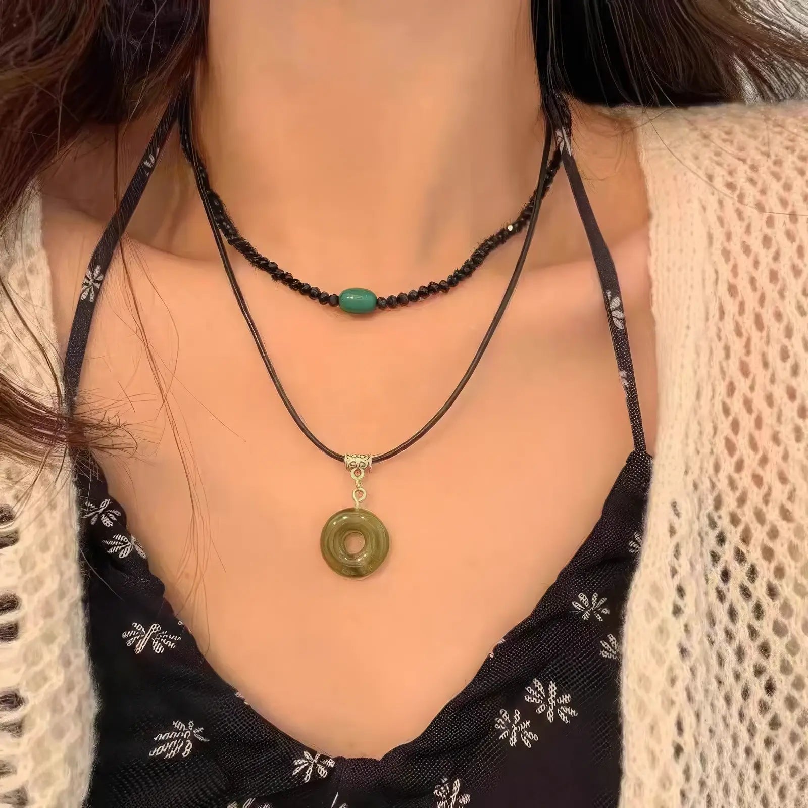 Vintage circular pendant 2 - piece set worn, paired with a floral dress and beige cardigan, showcasing style