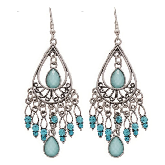 Water drop tassel earrings, blue stones with silver - tone filigree, isolated on white background (close - up)