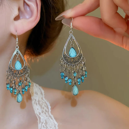 Water drop tassel earrings, blue stones with silver - tone filigree, worn on ear with lace top