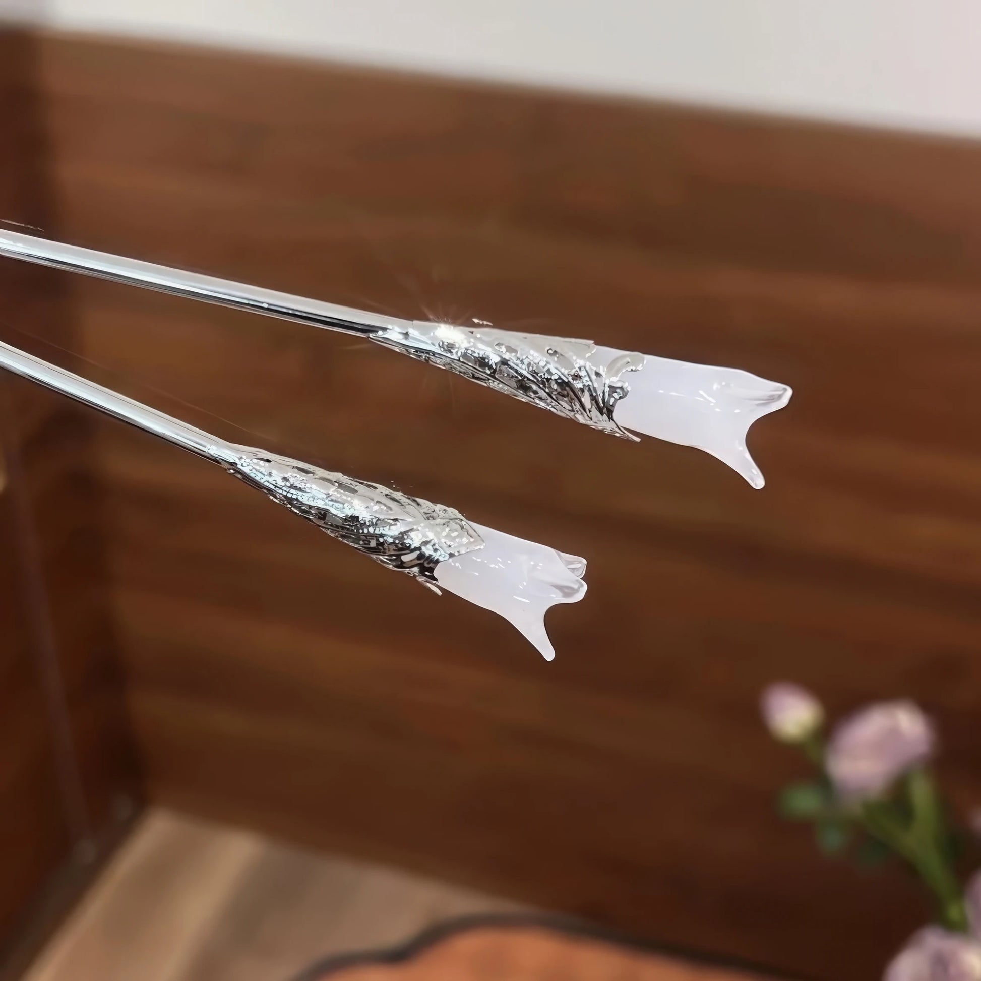 Pair of white magnolia hair pins, isolated on white background, highlighting design