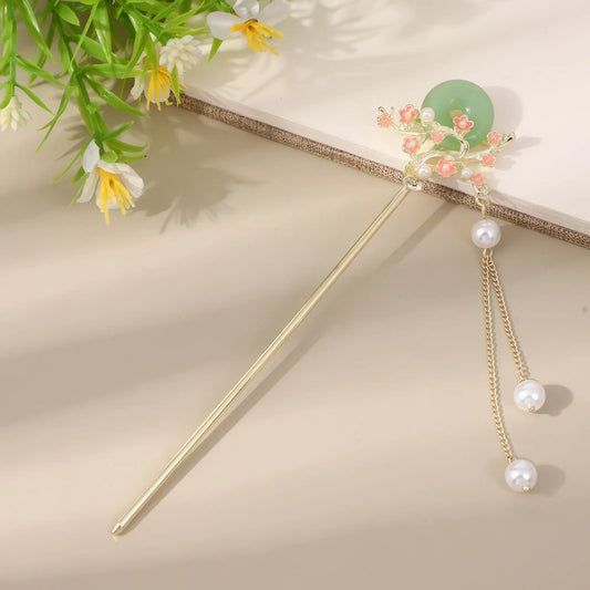 Xintingwang gold hairpin with green jade and pink flower, pearl tassel on beige background with greenery