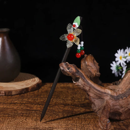 Yaotiao hairpin with floral and insect design, dark background with vase and daisies