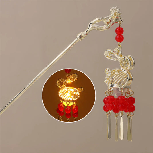 Youyou Luming lantern hairpin with rabbit design, red beads, and small lit yellow lantern inset, beige background